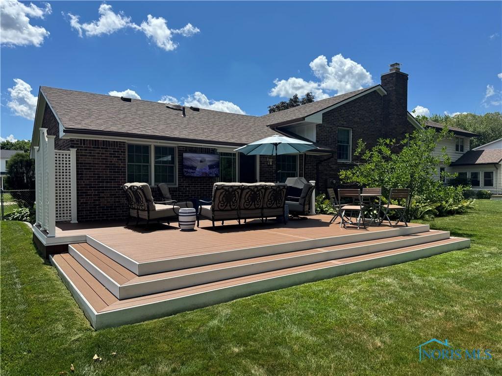 1240 Applegate St, Waterville, OH 43566 - rear view of house featuring brick siding, an outdoor hangout area, a yard, and a deck