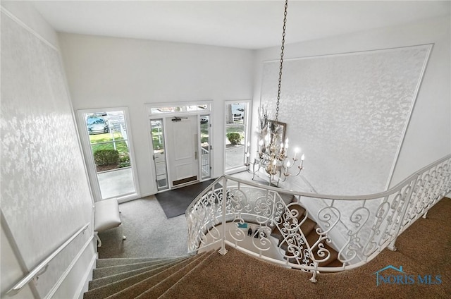 5679 Monroe St Unit 410, Sylvania, OH 43560 - entryway featuring carpet floors, a chandelier, and stairway