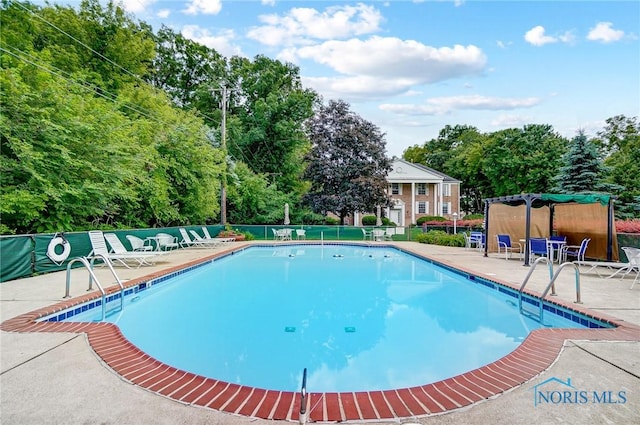 5679 Monroe St Unit 410, Sylvania, OH 43560 - community pool with a patio area and view of wooded area
