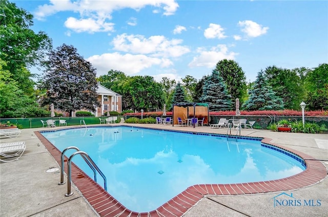 5679 Monroe St Unit 410, Sylvania, OH 43560 - community pool with a patio and view of scattered trees