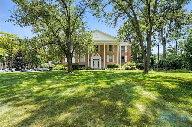 5679 Monroe St Unit 410, Sylvania, OH 43560 - greek revival house with a chimney, a front yard, and brick siding