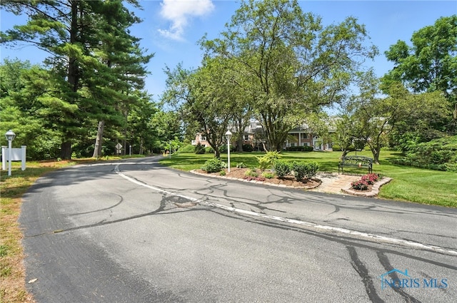 5679 Monroe St Unit 410, Sylvania, OH 43560 - view of asphalt street with street lights and view of scattered trees