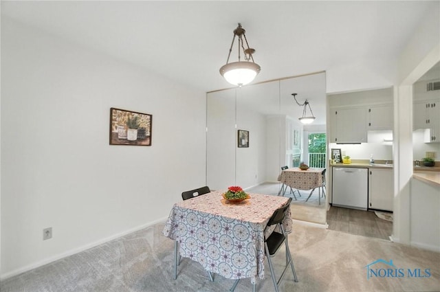 5679 Monroe St Unit 410, Sylvania, OH 43560 - dining area featuring light carpet and baseboards