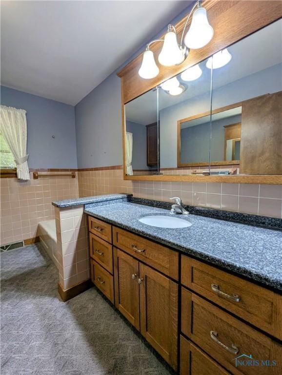 309 Buckeye St, Archbold, OH 43502 - full bath with vanity, tile walls, a bath, and wainscoting