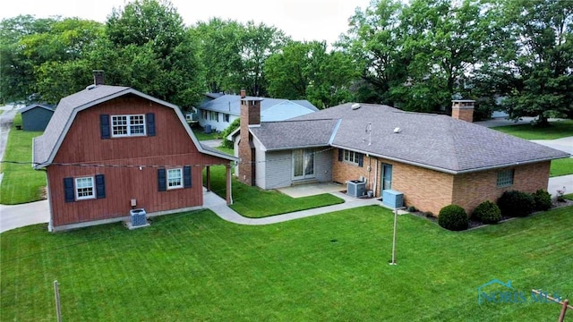 309 Buckeye St, Archbold, OH 43502 - back of house featuring a chimney, a lawn, a patio area, and a gambrel roof