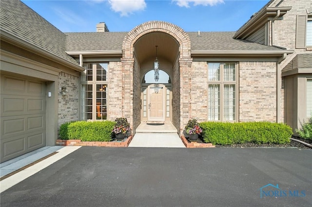 5576 N Citation Rd, Ottawa Hills, OH 43615 - entrance to property featuring brick siding, a chimney, and roof with shingles