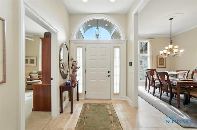 5576 N Citation Rd, Ottawa Hills, OH 43615 - foyer with a chandelier, light tile patterned floors, and ornamental molding
