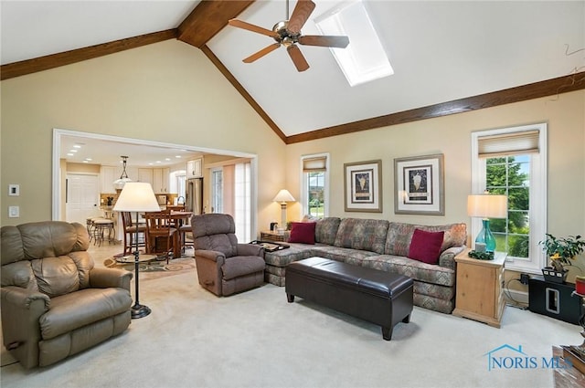 5576 N Citation Rd, Ottawa Hills, OH 43615 - living room with light colored carpet, high vaulted ceiling, ceiling fan, a skylight, and beamed ceiling