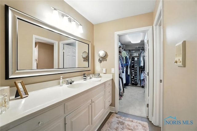 5576 N Citation Rd, Ottawa Hills, OH 43615 - bathroom featuring vanity, a spacious closet, and tile patterned floors