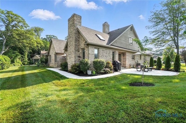 5576 N Citation Rd, Ottawa Hills, OH 43615 - back of property featuring a patio, a lawn, brick siding, and roof with shingles