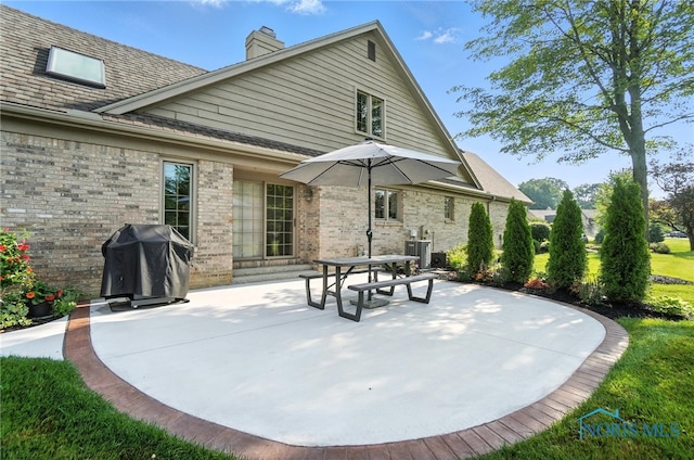 5576 N Citation Rd, Ottawa Hills, OH 43615 - back of property with a chimney, a patio, and brick siding