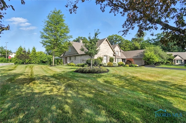 5576 N Citation Rd, Ottawa Hills, OH 43615 - view of front facade featuring stone siding, a front yard, and a chimney