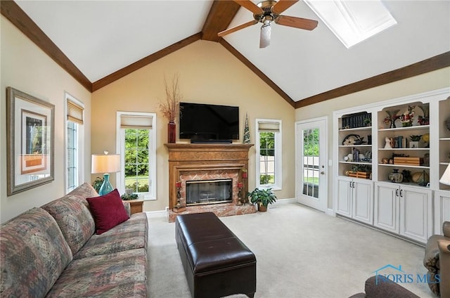 5576 N Citation Rd, Ottawa Hills, OH 43615 - living area with ceiling fan, light carpet, a fireplace, a skylight, and lofted ceiling
