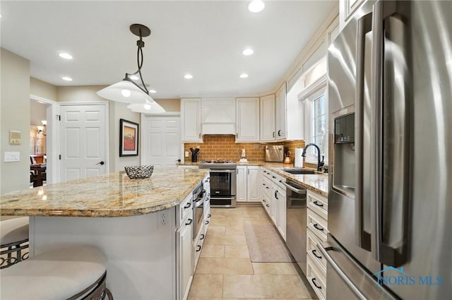 5576 N Citation Rd, Ottawa Hills, OH 43615 - kitchen featuring stainless steel appliances, custom range hood, a center island, backsplash, and a kitchen breakfast bar