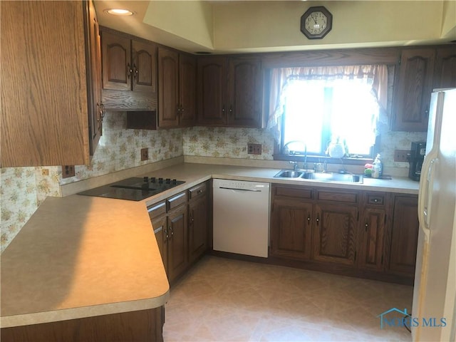 4815 298th St, Toledo, OH 43611 - kitchen with white appliances, light countertops, decorative backsplash, and wallpapered walls