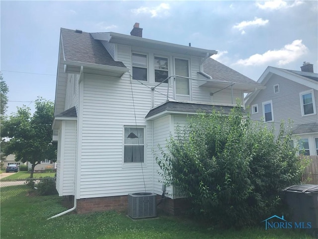 4815 298th St, Toledo, OH 43611 - view of side of home with a shingled roof and a chimney