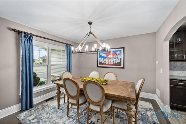 9258 Nate Ct, Sylvania, OH 43560 - dining room featuring arched walkways and a chandelier