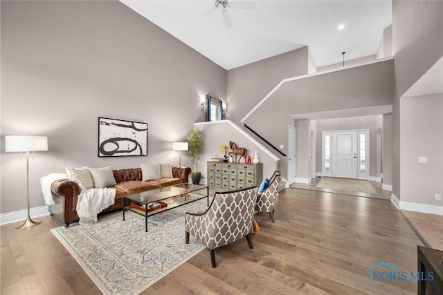 9258 Nate Ct, Sylvania, OH 43560 - living area featuring wood finished floors, ceiling fan, stairs, and a high ceiling