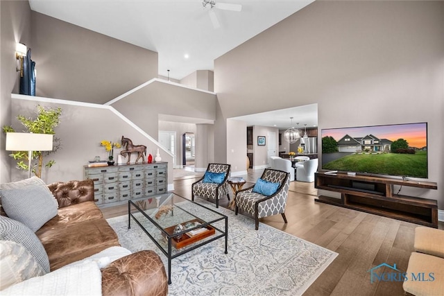 9258 Nate Ct, Sylvania, OH 43560 - living area featuring wood finished floors, a chandelier, ceiling fan, and high vaulted ceiling