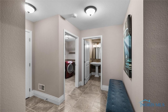 9258 Nate Ct, Sylvania, OH 43560 - hallway with washer / clothes dryer, tile patterned floors, and a textured wall