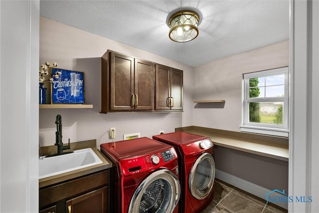 9258 Nate Ct, Sylvania, OH 43560 - laundry room featuring cabinet space, separate washer and dryer, dark tile patterned flooring, and a textured ceiling
