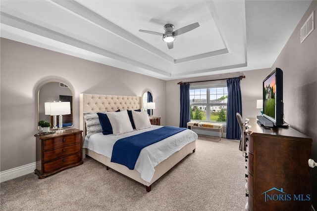 9258 Nate Ct, Sylvania, OH 43560 - bedroom with a tray ceiling, light carpet, and ceiling fan