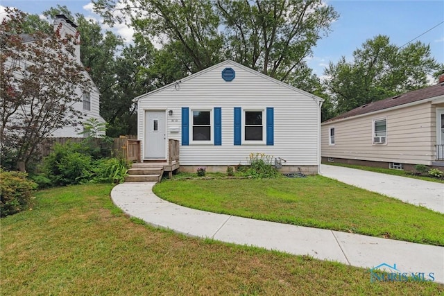 2713 Stateview Dr, Toledo, OH 43609 - view of front of home with a front lawn and cooling unit