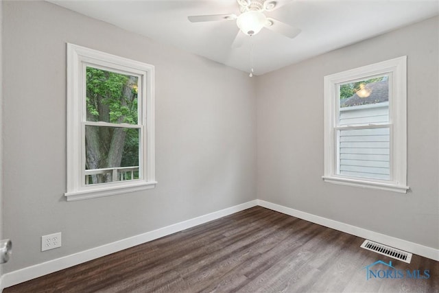2713 Stateview Dr, Toledo, OH 43609 - spare room featuring healthy amount of natural light, dark wood-type flooring, and a ceiling fan