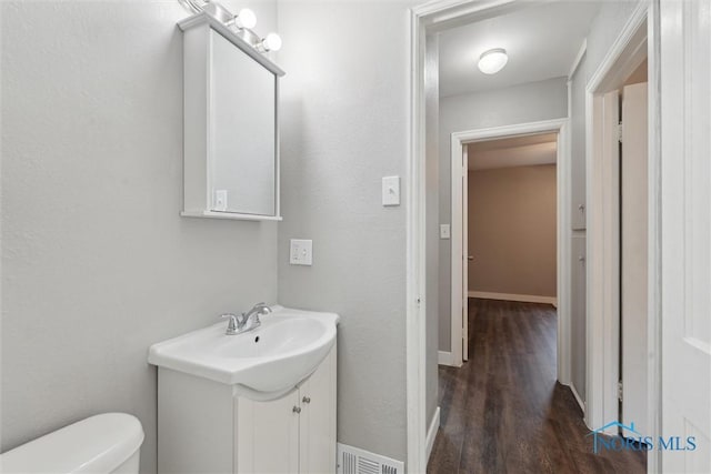2713 Stateview Dr, Toledo, OH 43609 - half bathroom with vanity and wood finished floors