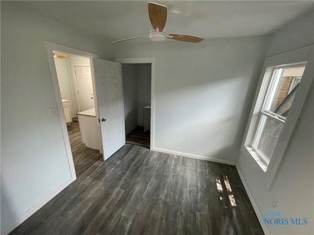 1221 E Broadway St, Toledo, OH 43605 - unfurnished bedroom featuring dark wood-style floors and a ceiling fan