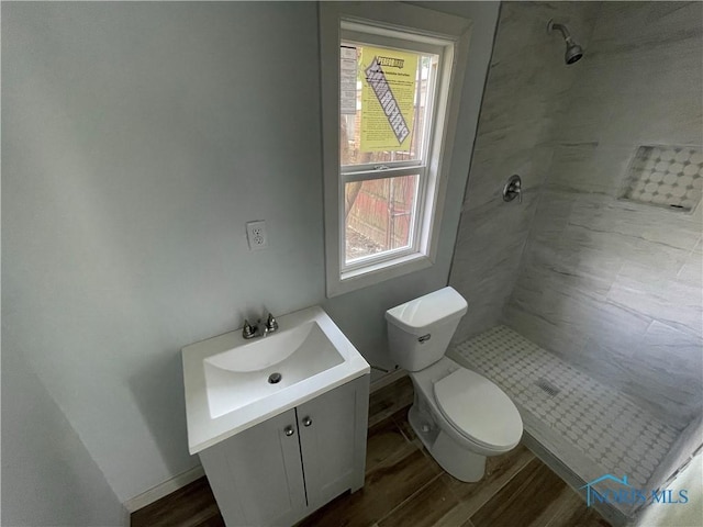 1221 E Broadway St, Toledo, OH 43605 - full bathroom with a tile shower, vanity, and wood finished floors