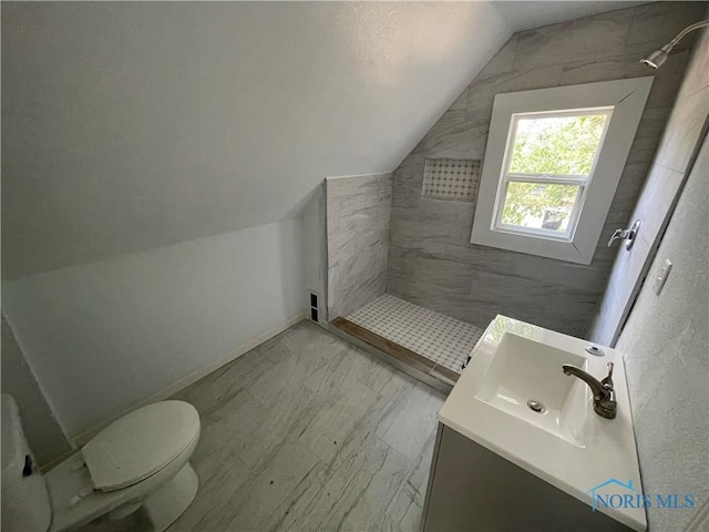 1221 E Broadway St, Toledo, OH 43605 - full bath featuring lofted ceiling, a tile shower, vanity, and marble look tile flooring
