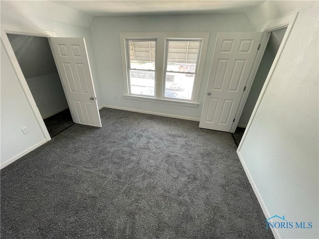 1221 E Broadway St, Toledo, OH 43605 - unfurnished bedroom featuring dark colored carpet and lofted ceiling