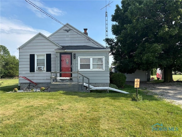 3706 Corduroy Rd, Oregon, OH 43616 - view of front of home with a front lawn, cooling unit, and a chimney