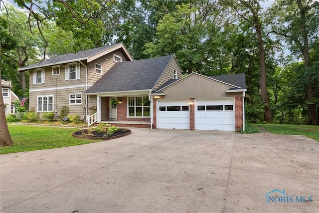 1673 Watova Rd, Toledo, OH 43614 - traditional-style house featuring an attached garage, brick siding, concrete driveway, and a front lawn