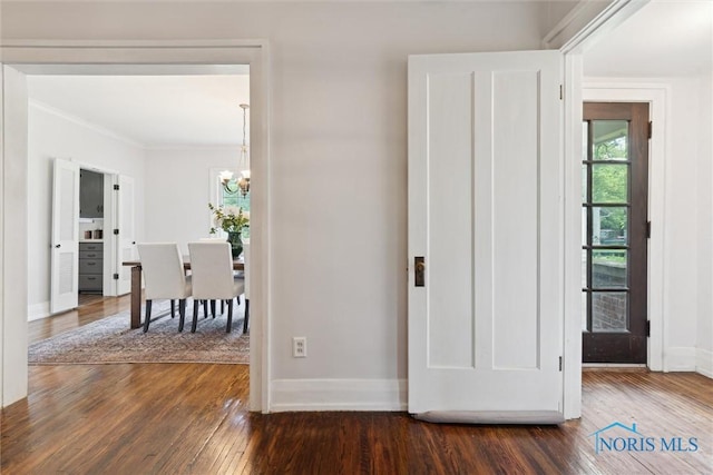 1673 Watova Rd, Toledo, OH 43614 - hall featuring a chandelier, dark wood-style flooring, and crown molding