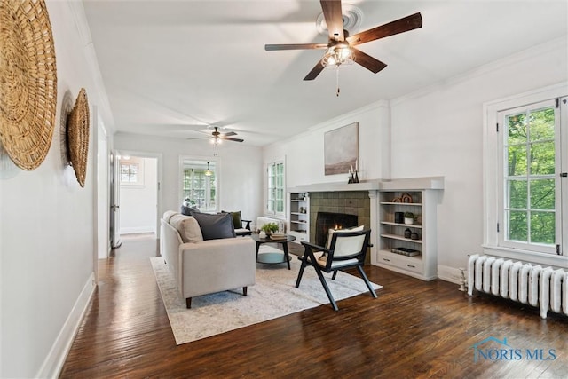 1673 Watova Rd, Toledo, OH 43614 - living area featuring radiator, plenty of natural light, wood-type flooring, ceiling fan, and ornamental molding