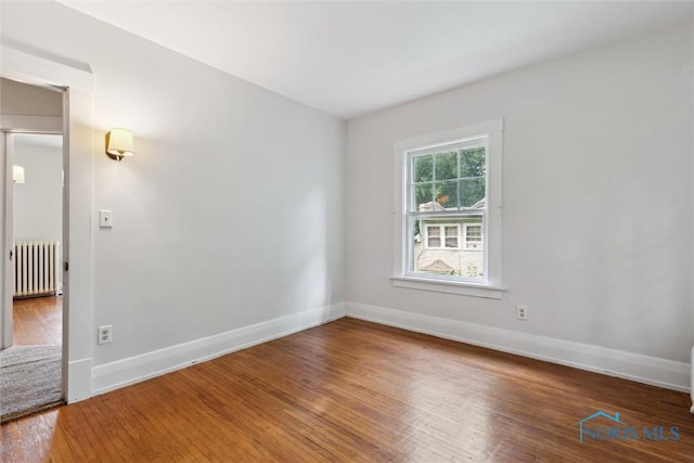 1673 Watova Rd, Toledo, OH 43614 - empty room with radiator and hardwood / wood-style flooring