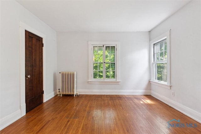 1673 Watova Rd, Toledo, OH 43614 - unfurnished room featuring radiator heating unit and hardwood / wood-style floors