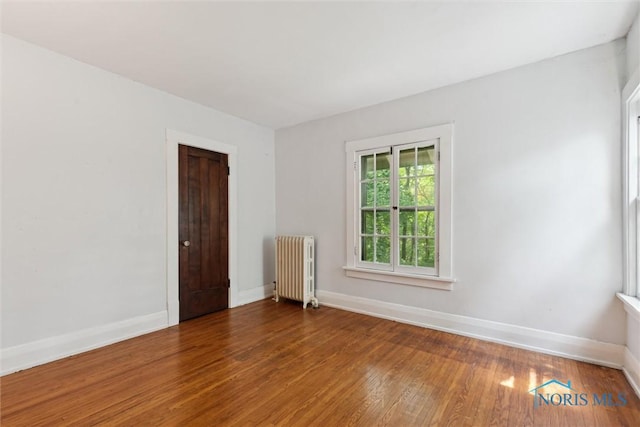 1673 Watova Rd, Toledo, OH 43614 - spare room featuring radiator and hardwood / wood-style flooring
