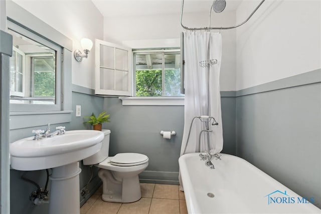 1673 Watova Rd, Toledo, OH 43614 - full bath featuring a soaking tub, tile patterned flooring, and curtained shower