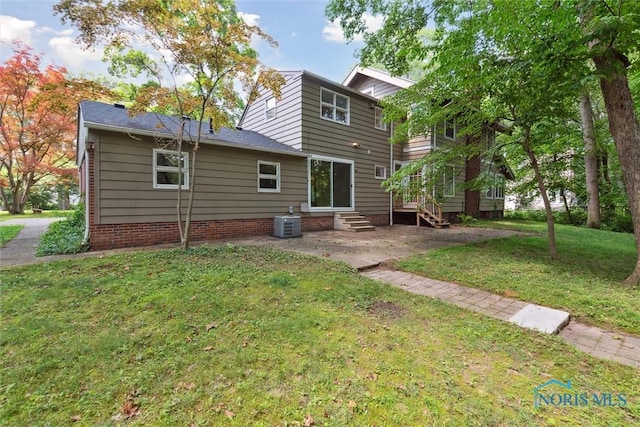 1673 Watova Rd, Toledo, OH 43614 - back of house featuring entry steps, a yard, and a patio area