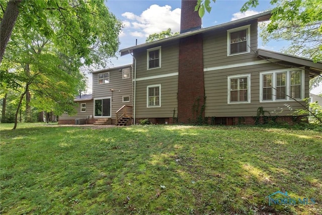 1673 Watova Rd, Toledo, OH 43614 - back of house featuring a chimney, entry steps, and a yard
