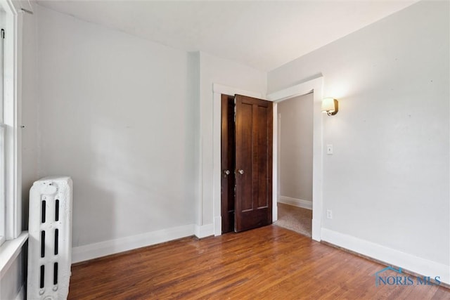 1673 Watova Rd, Toledo, OH 43614 - empty room featuring radiator and wood finished floors
