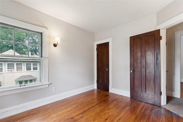 1673 Watova Rd, Toledo, OH 43614 - unfurnished bedroom with wood finished floors and baseboards