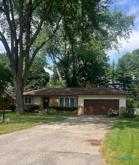 4855 Clover Ln, Toledo, OH 43623 - ranch-style house with a garage, concrete driveway, a front lawn, and a chimney