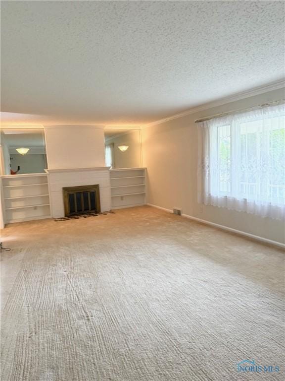 125 E Yates Ave, Findlay, OH 45840 - unfurnished living room with a textured ceiling, crown molding, carpet floors, and a fireplace with flush hearth