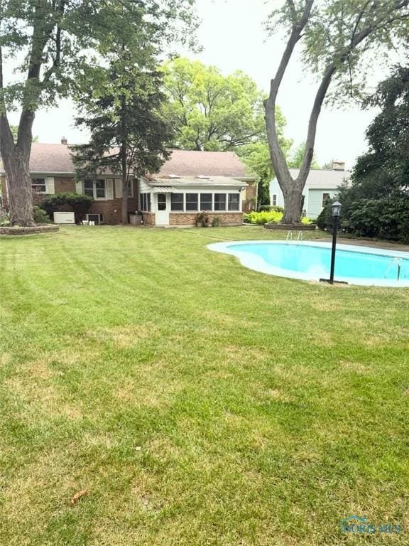 125 E Yates Ave, Findlay, OH 45840 - swimming pool featuring a lawn