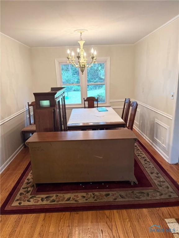 125 E Yates Ave, Findlay, OH 45840 - dining space with a chandelier, wood finished floors, and crown molding