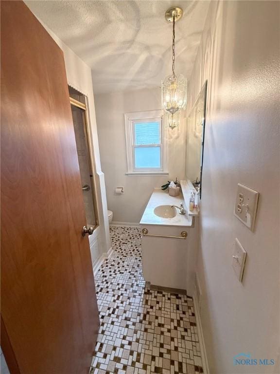 125 E Yates Ave, Findlay, OH 45840 - bathroom featuring vanity, tile patterned floors, a textured ceiling, a chandelier, and bath / shower combo with glass door